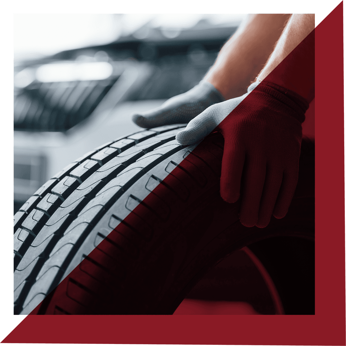 Hands holding a car tyre